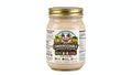 A glass jar of Condensedable Creamery Cinnamon Milk with a gold metal lid and a white label featuring a cartoon cow, shown on a plain white background.