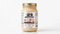 A glass jar of Condensedable Brand Condensed Peanut Butter with a gold metal lid and a white label, set against a plain white background.